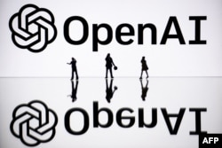 FILE - This illustration photograph taken on October 30, 2023, in Mulhouse, eastern France, shows figurines next to a screen displaying a logo of OpenAI, a US artificial intelligence organization. (Photo by SEBASTIEN BOZON / AFP)