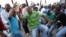 Striking miners dance and cheer after they were informed of a 22 percent wage increase offer outside Lonmin's Marikana mine, 100 km (60 miles) northwest of Johannesburg, September 18, 2012. 