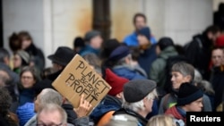 FILE - People attend a climate change protest in Brussels, Belgium, Dec. 8, 2019.