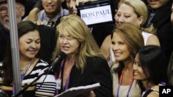 Minnesota Representative Michele Bachmann, second right, listens as Minnesota delegates casts their vote for Romney during Republican Convention, Aug. 28, 2012 