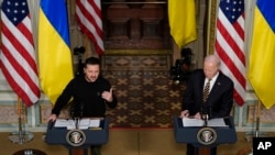 FILE - Ukrainian President Volodymyr Zelenskyy speaks during a news conference with President Joe Biden in the Indian Treaty Room in the Eisenhower Executive Office Building on the White House Campus, Tuesday, Dec. 12, 2023, in Washington.