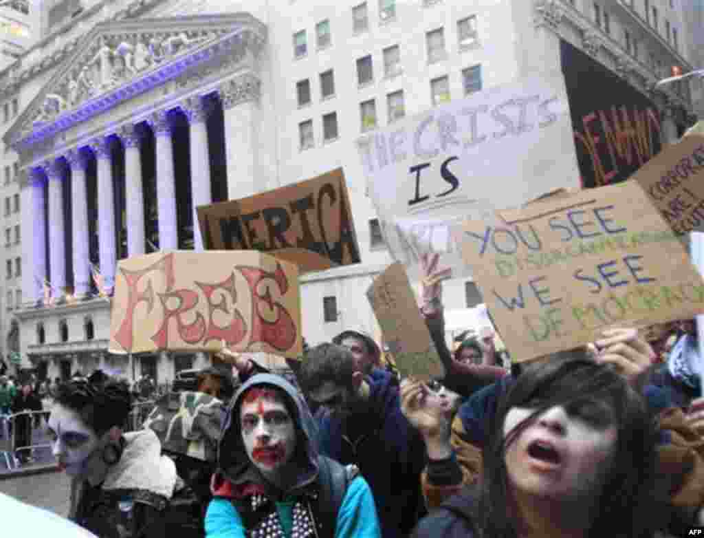 Protesters from Occupy Wall Street walk past the New York Stock Exchange dressed as corporate zombies Monday, Oct. 3, 2011, in New York. The protests have gathered momentum and gained participants in recent days as news of mass arrests and a coordinated m
