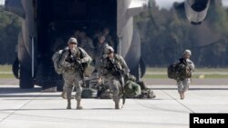 FILE - Soldiers from the U.S. 173 airborne brigade, who are among the troops participating in the exercises in western Ukraine, are seen exiting a C-130 transport plane.