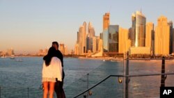 Tourists look at the skyline at sunset in Dubai, UAE, Jan. 12, 2021.