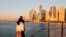Tourists look at the skyline at sunset in Dubai, UAE, Jan. 12, 2021.