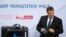 FILE - German Economy Minister Sigmar Gabriel is seen examining items at a technology summit in Berlin, Germany, Nov. 19, 2015.