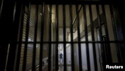 A guard stands behind bars at the Adjustment Center during a media tour of California's Death Row at San Quentin State Prison in San Quentin, California Dec. 29, 2015.