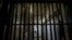 FILE - A guard stands behind bars at a prison in California, Dec. 29, 2015. Inmates from an eastern Iowa prison have been invited to sing in a New York City production of Beethoven's "Fidelio."