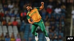 South Africa's Tabraiz Shamsi celebrates after the dismissal of Afghanistan's Karim Janat (out of frame) during the ICC men's Twenty20 World Cup 2024 semi-final cricket match between South Africa and Afghanistan at Brian Lara Cricket Academy in Tarouba, T