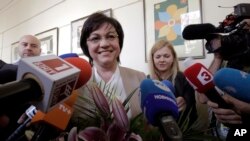 Bulgarian Socialists' Party leader Kornelia Ninova smiles after casting her vote in Sofia, Bulgaria on Sunday, March 26, 2017. 