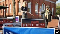 罗姆尼竞选团队的一名志愿者(左)4月3日在首都华盛顿的一个投票站接待一名共和党选民