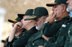 Gen. Qassem Soleimani, center, who heads the elite Quds Force of Iran's Revolutionary Guard attends a graduation ceremony of a group of the guard's officers in Tehran, Iran, June 30, 2018.