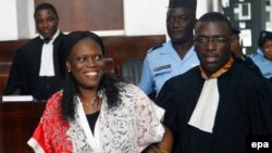 L’ancienne première dame de la Côte-d'Ivoire, Simone Gbagbo, à gauche, est accompagnée de son avocat, au premier jour de son procès à la Cour Abidjan Justice, Côte-d'Ivoire, 31 mai 2016. epa / LEGNAN KOULA