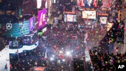 FILE - In this Jan. 1, 2017 file photo, revelers celebrate the new year as confetti flies over New York's Times Square.