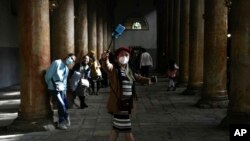 People visit the Church of the Nativity, traditionally believed to be the birthplace of Jesus Christ, on Christmas Day in the West Bank city of Bethlehem, Saturday, Dec. 25, 2021.