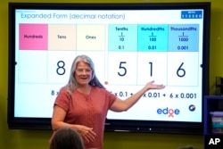 FILE - Elementary math teacher Margie Howells teaches a fifth-grade class at Wheeling Country Day School in Wheeling, W.Va., on Tuesday, Sept. 5, 2023. (AP Photo/Gene J. Puskar)