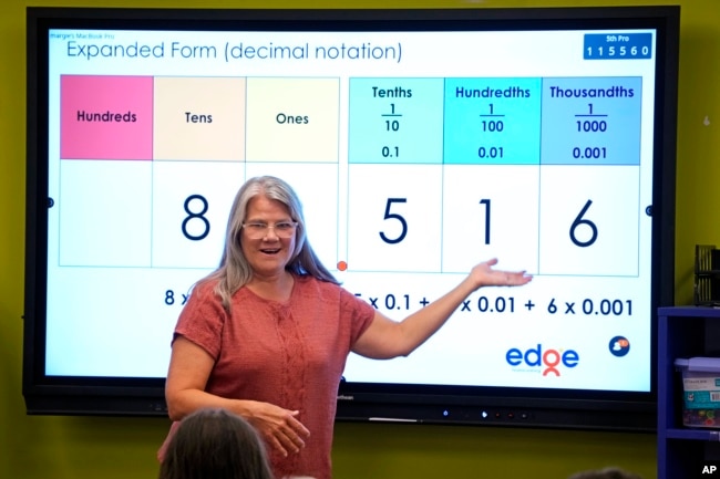 FILE - Elementary math teacher Margie Howells teaches a fifth-grade class at Wheeling Country Day School in Wheeling, W.Va., on Tuesday, Sept. 5, 2023. (AP Photo/Gene J. Puskar)