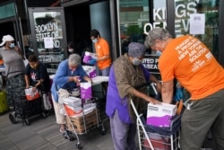 The elderly collect fresh produce and shelf-stable pantry items outside Barclays Center as Food Bank For New York City provides assistance to those in need due to the COVID-19 pandemic, in New York, Sept. 10, 2020.