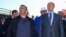 FILE - Russian President Vladimir Putin, right, flanken by businessman and billionaire Arkady Rotenberg, visit the construction site of the Kerch Strait bridge in Kerch, Crimea, Sept. 15, 2016.