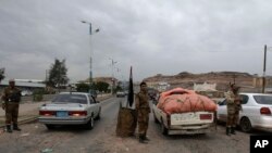 Yemeni soldiers inspect cars at a checkpoint leading to the U.S. embassy in Sanaa, Yemen, Aug. 4, 2013, one of 21 U.S. diplomatic missions ordered closed for the weekend due to the threat of an al-Qaida attack.