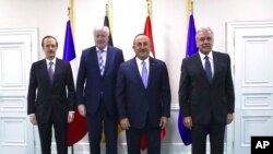 From left, Charles Fries, France ambassador, Germany's Interior Minister Horst Seehofer, Turkey's FM Mevlut Cavusoglu and EU Commissioner for Migration, Home Affairs and Citizenship Dimitris Avramopoulos, pose for photos in Ankara, Oct. 4, 2019.