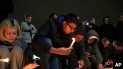 FILE—People light candles in memory of the victims of the terrorist attack in Moscow, in the center of in the center of Simferopol, in Russian-held Crimea, March 22, 2024.