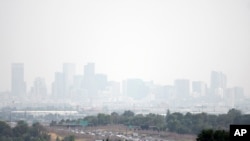 Haze hangs in the air over downtown Denver, July 24, 2024. Fires burning in western states, as well as Canada, have filled the skies with smoke and haze, forcing some affected areas to declare air quality alerts or advisories. 