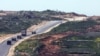 A convoy of military vehicles moves inside Gaza, as seen from the Israeli side, at the the border between Israel and Gaza, March 5, 2025.