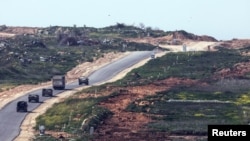 A convoy of military vehicles moves inside Gaza, as seen from the Israeli side, at the the border between Israel and Gaza, March 5, 2025.