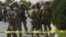  FILE - U.S. soldiers and Afghan security personnel investigate at the site of an attack in Kabul, Afghanistan, Sept. 24, 2017.