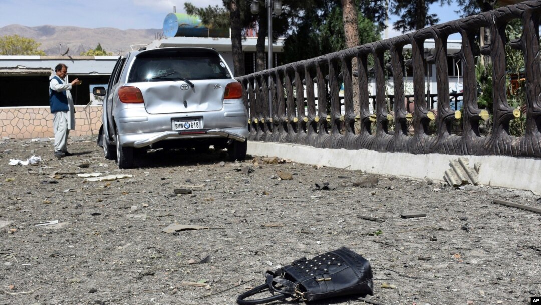 A man takes pictures at the site of a car bomb blast on an intelligence compound in Aybak, the capital of the Samangan province in northern Afghanistan, Monday, July 13, 2020. Taliban insurgents launched a complex attack on the compound that began…