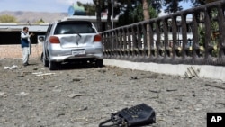 A man takes pictures at the site of a car bomb blast on an intelligence compound in Aybak, the capital of the Samangan province in northern Afghanistan, Monday, July 13, 2020. Taliban insurgents launched a complex attack on the compound that began…