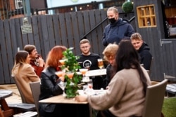 Customers at The Swinging Witch pub enjoy drinks, as lockdown eases amid the coronavirus disease (COVID-19) pandemic, in Northwich, Cheshire, Britain, May 15, 2021.