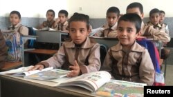 FILE - Iranian and Afghan boys study in a classroom at the Be'sat school in Kerman, Iran, October 23, 2016. (REUTERS/Gabriela Baczynska)