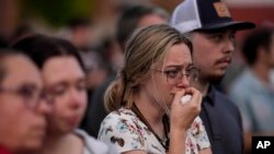 Mourners pray during a candlelight vigil for the slain students and teachers at Apalachee High School, in Winder, Georgia, Sept. 4, 2024.