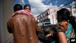 Mayra Cristina Gregorio Velásquez, de siete años, es llevada por su padre después de que se reunieron en el refugio "Nuestras Raíces", luego de su detención por las autoridades de inmigración de EE.UU. en la ciudad de Guatemala, el 7 de agosto de 2018.