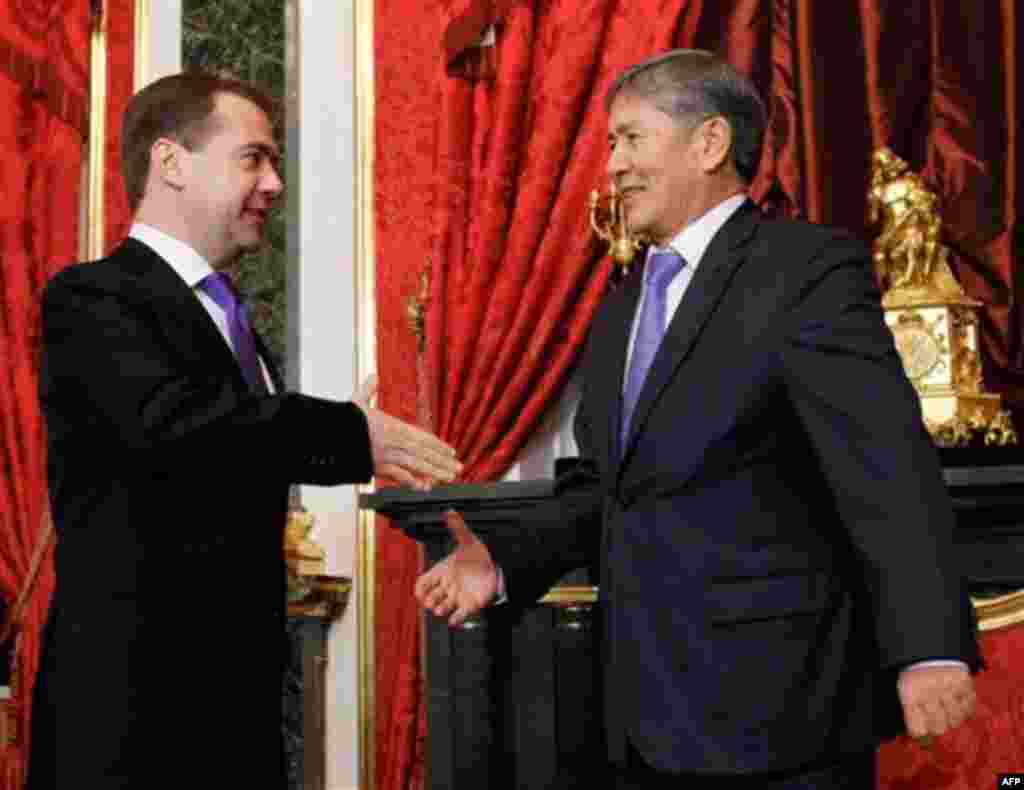 Russian President Dmitry Medvedev, left, greets Kyrgyz President Almazbek Atambayev before a summit of the Collective Security Treaty Organization in the Kremlin in Moscow, Tuesday, Dec. 20, 2011. (AP Photo/RIA Novosti, Dmitry Astakhov, Presidential Press