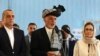 FILE - Afghan President Ashraf Ghani, center, speaks to journalists after voting at Amani high school, near the presidential palace in Kabul, Afghanistan, Sept. 28, 2019.