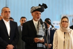 Afghan President Ashraf Ghani, center, speaks to journalists after voting at Amani high school, near the presidential palace in Kabul, Afghanistan, Sept. 28, 2019.