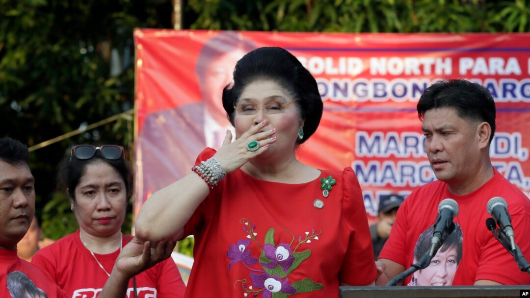FILE - Former Philippine First Lady Imelda Marcos blows kisses to supporters. The Philippine government will launch a website to crowd-source tips on the whereabouts of some 200 missing art works formerly owned by Marcos.
