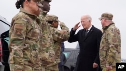 FILE - President Joe Biden greets service members after arriving at Dover Air Force Base, Del., February 2, 2024.