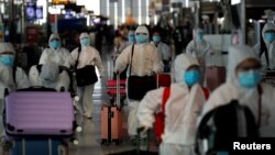 21 Nisan 2020 - Tayland'dan ülkeleri Çin'e dönen öğrenciler Bangkok'taki Suvarnabhumi Havaalanı'nda koruyucu giysi ve maskeleriyle böyle görüntülendi