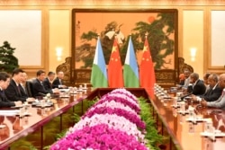 FILE - China's President Xi Jinping attends a meeting with Djibouti's President Ismail Omar Guelleh at the Great Hall of the People in Beijing, April 28, 2019.