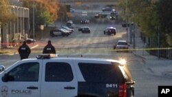 Police tape marks off the scene after authorities shot and killed a man who they say opened fire on the Mexican Consulate, police headquarters and other downtown buildings in Austin, Texas, Nov. 28, 2014.