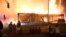 Manifestantes se reunieron cerca del tercer precinto policial en Minneapolis, Minnesota, EE.UU., para observar el incendio de un sitio después que un policía blanco fue visto en un video presionando el cuello de George Floyd, un afroamericano.