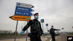 Carabinieri officers patrol one of the main access road to Bollate, in the outskirts of Milan, Italy.