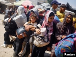 Palestinci, koji su pobegli iz istočnih delova Kan Junisa sledeći naloge izraelske vojske za evakuaciju, voze se na vozilu napunjenom njihovi stvarima, u Kan Junisu, na jugu Pojasa Gaze, 2. jula 2024.