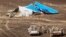 In this photo made available Nov. 2, 2015, and provided by Russian Emergency Situations Ministry, Egyptian military forces approach a plane's tail at the wreckage of a passenger jet bound for St. Petersburg in Russia that crashed in Hassana, Egypt, Nov. 1