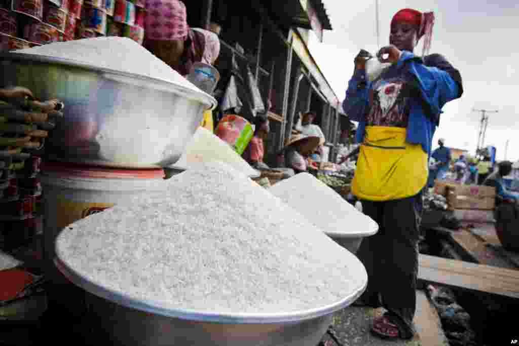 GHANA: Soaring prices put rice out of reach for many as a vendor tried to sell small packages of rice to customers at the Agbogboloshie food market in Accra, Ghana on Friday June 6, 2008. Food riots followed.&nbsp;