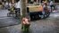 FILE - Flowers left for the victims in a school knife attack in Shanghai, China, June 28, 2018. Thursday a car plowed through a crowd of children outside a primary school, killing five and injuring 18.